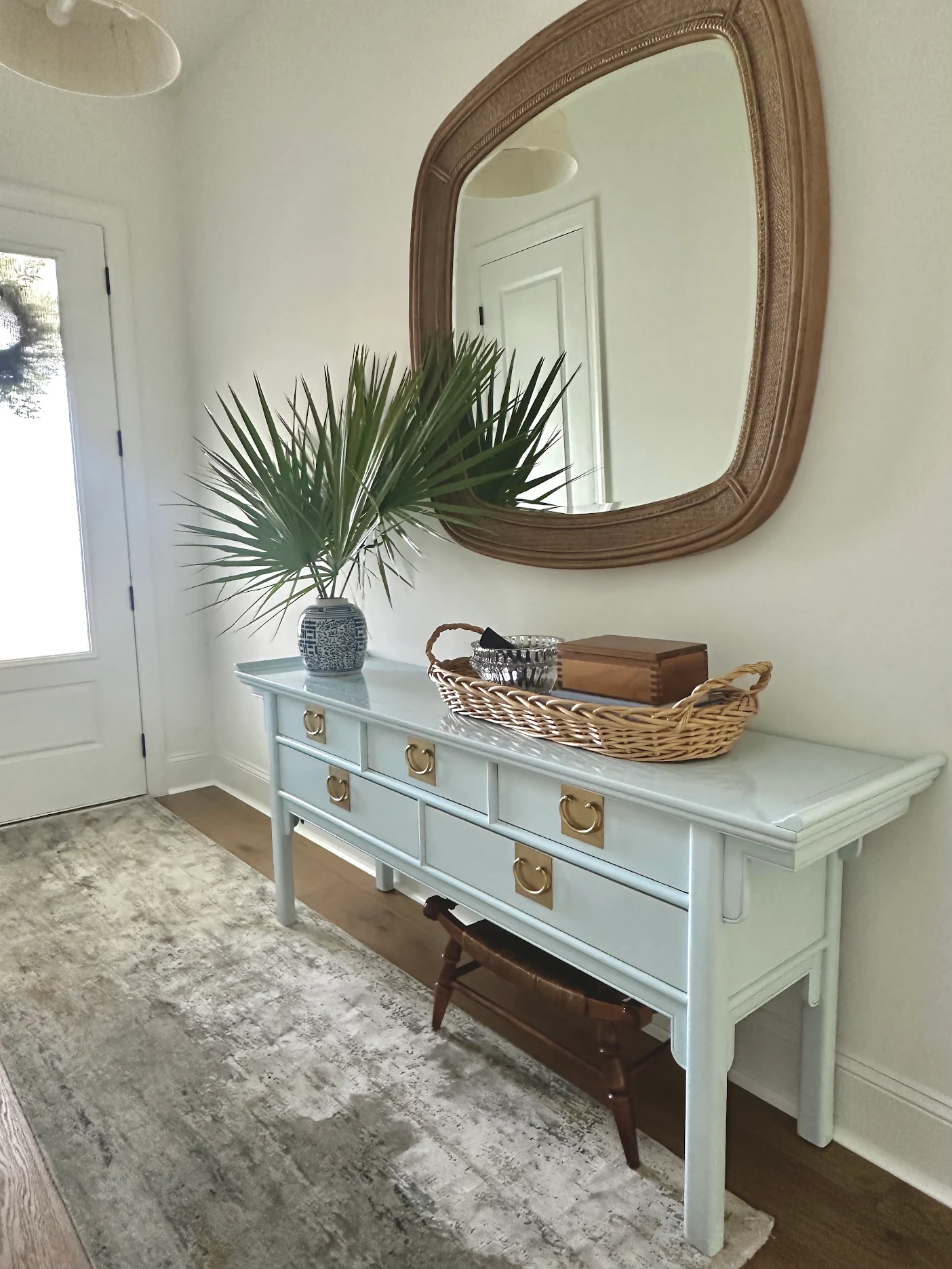 Custom refinished pale blue desk with brass hardware in Christine’s home